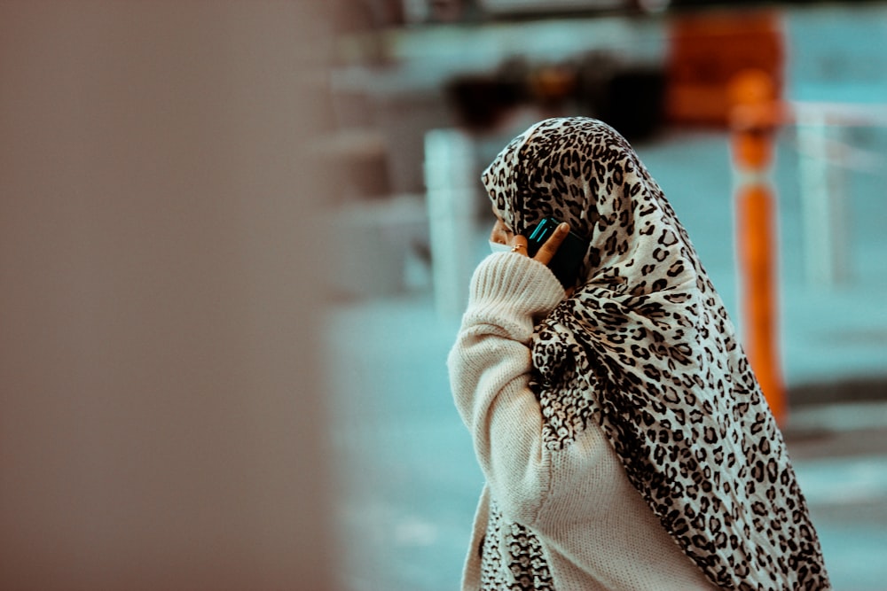 woman in black and white leopard print scarf