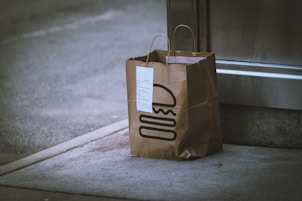 brown paper bag on gray concrete floor