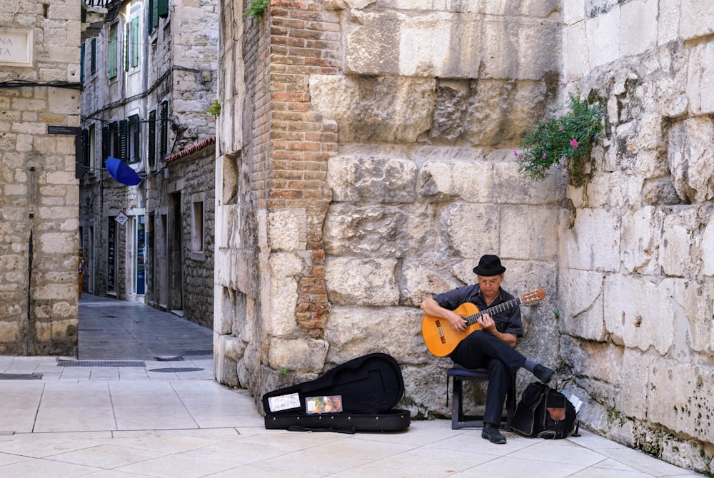 man in black shirt playing guitar