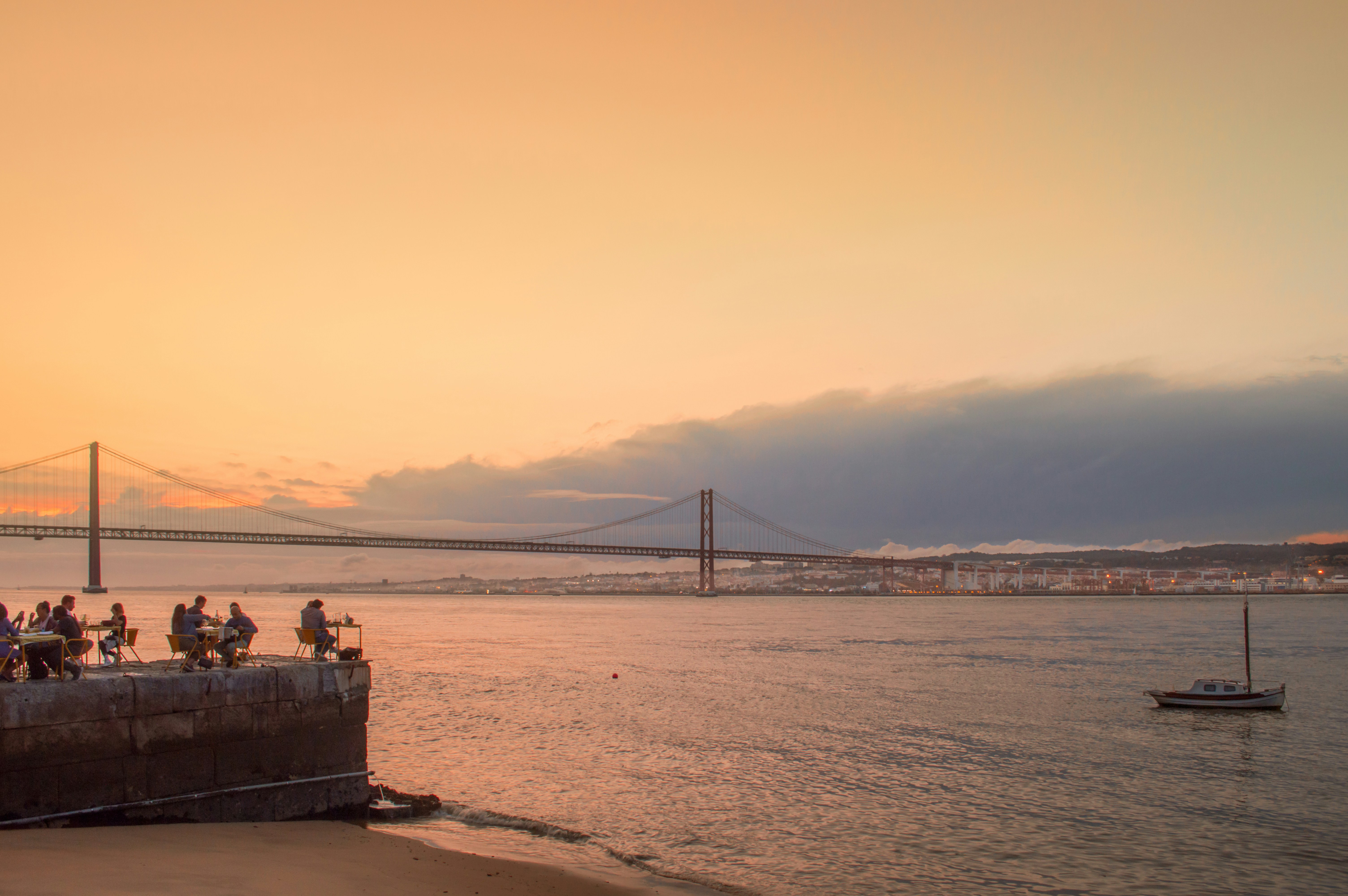 people sitting on brown wooden bench near body of water during daytime, Lisbon,views, river Tagus, sunset