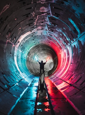 architectural photography,how to photograph man in blue shirt and black pants standing on tunnel