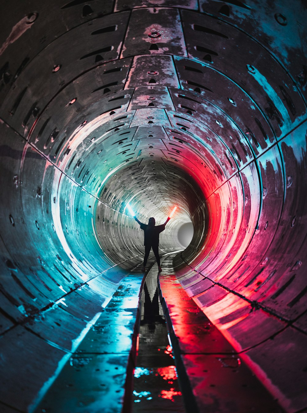 man in blue shirt and black pants standing on tunnel