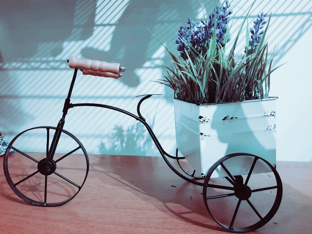 white and black trike on brown wooden table