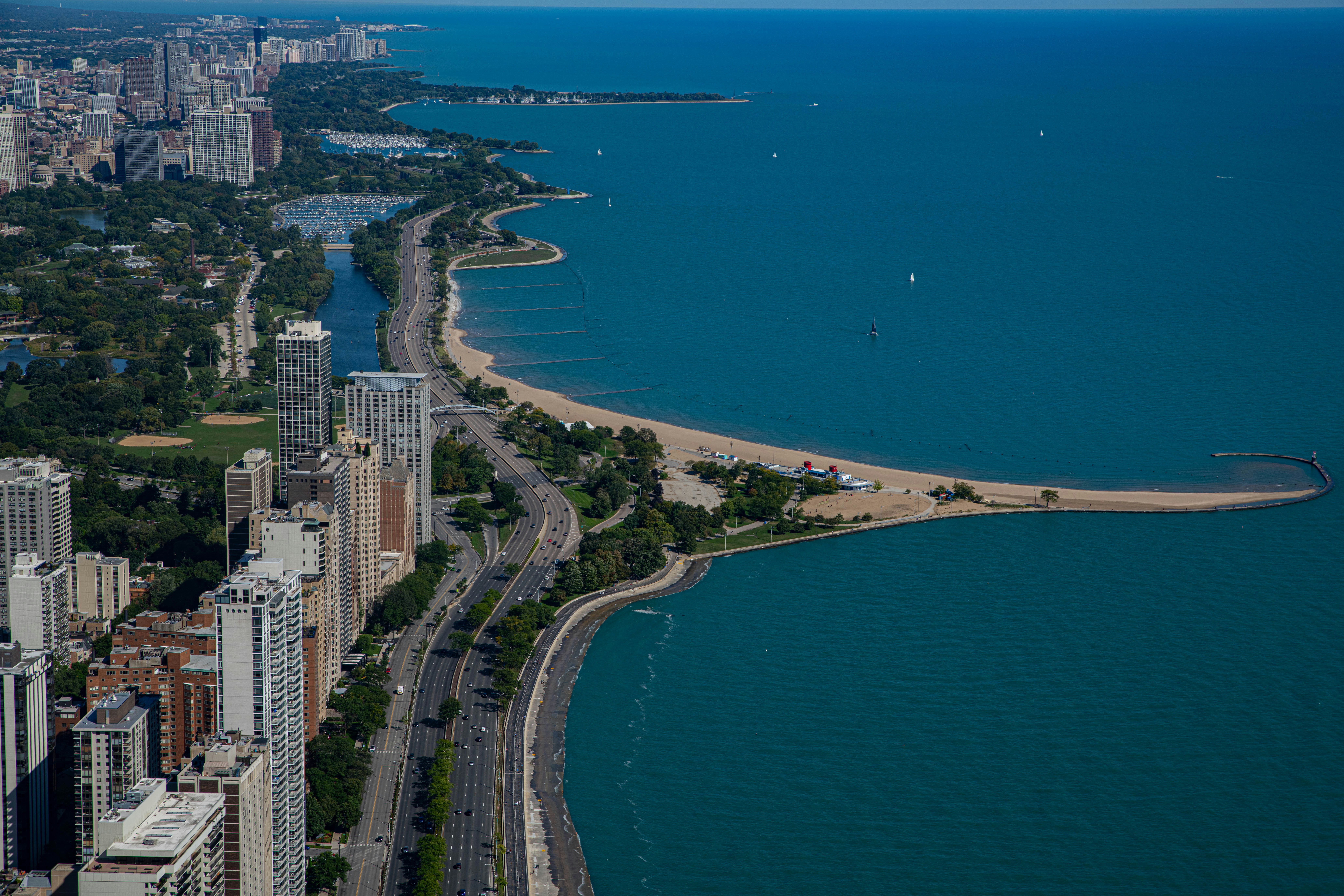 aerial view of city buildings near body of water during daytime