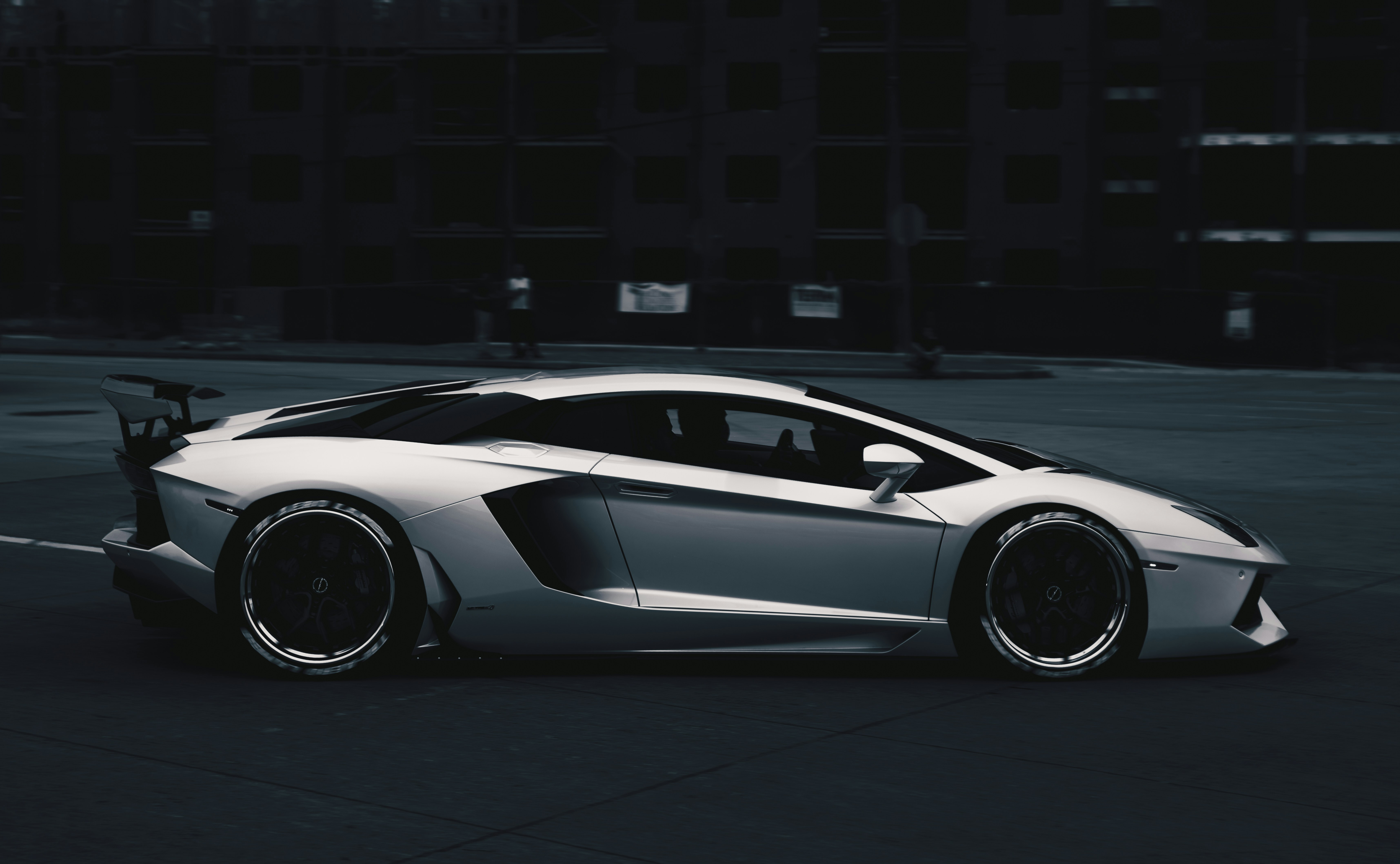 white lamborghini aventador parked on parking lot