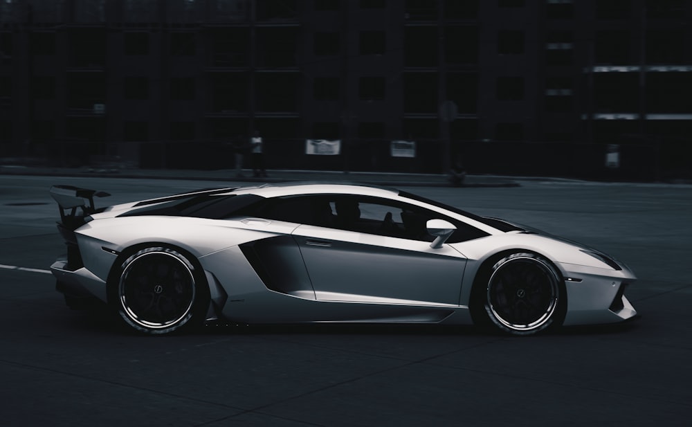 white lamborghini aventador parked on parking lot