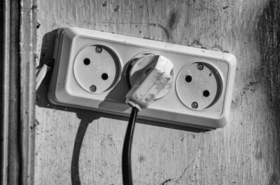 Close-up of hands fixing a household electrical outlet.