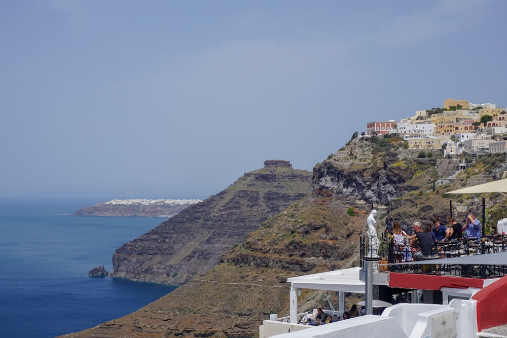 people standing on white wooden stairs on top of mountain during daytime