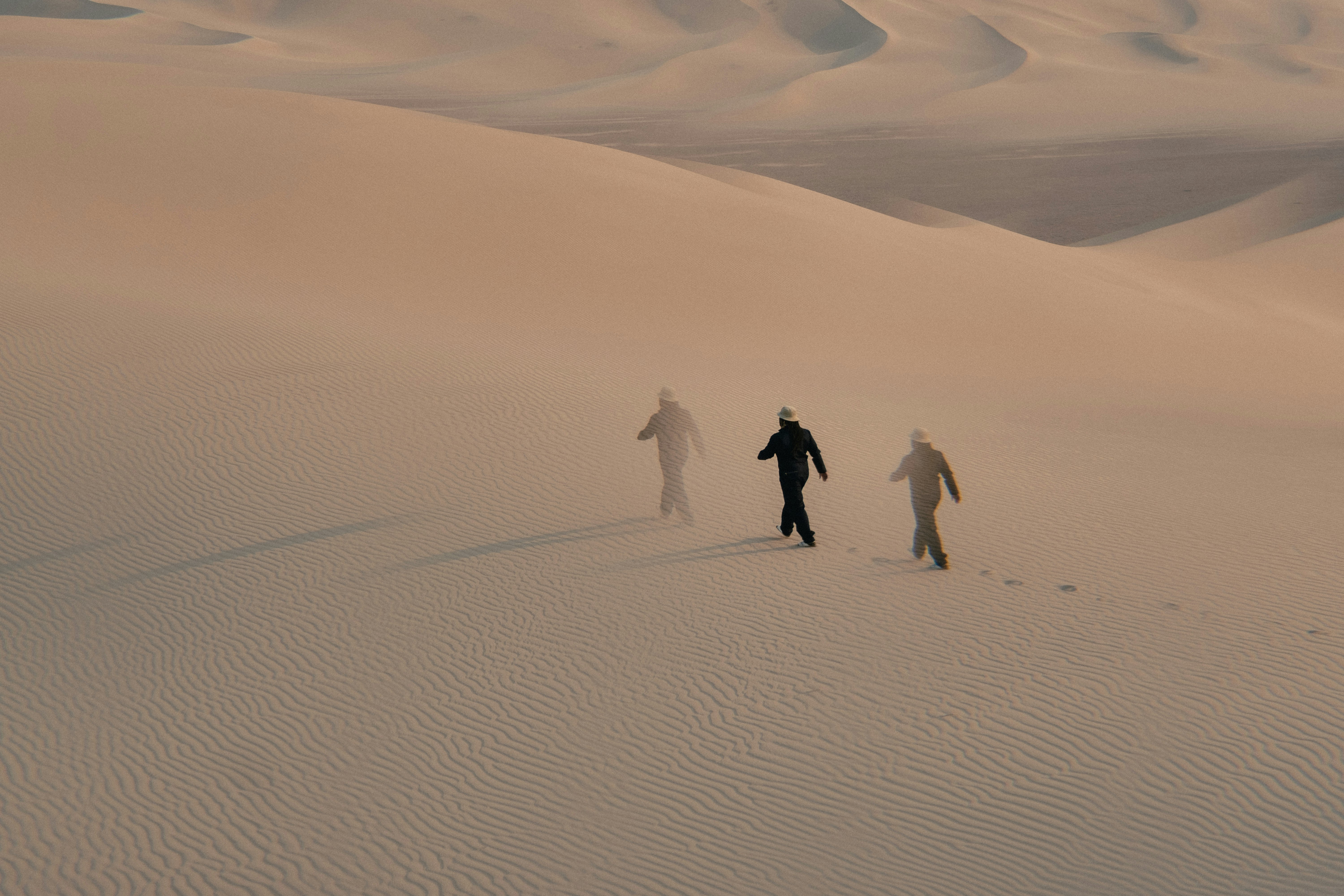 people walking on white sand during daytime