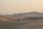 person walking on snow covered field during daytime