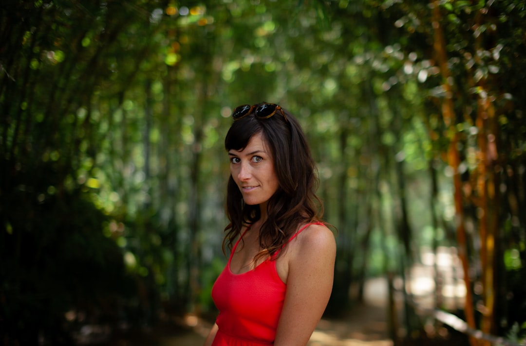 woman in red tank top wearing black sunglasses