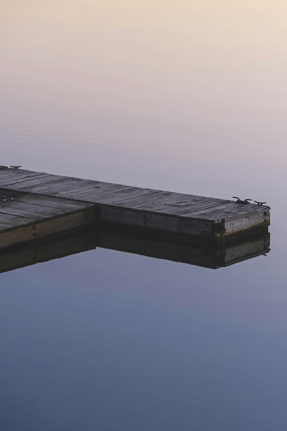 brown wooden dock on body of water