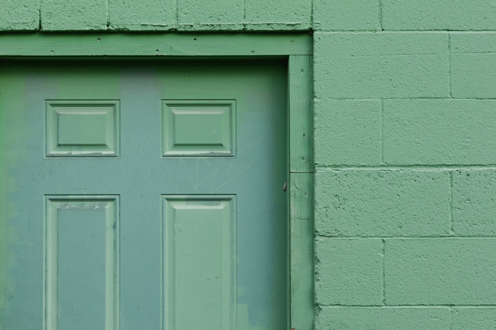 white wooden door on gray concrete wall