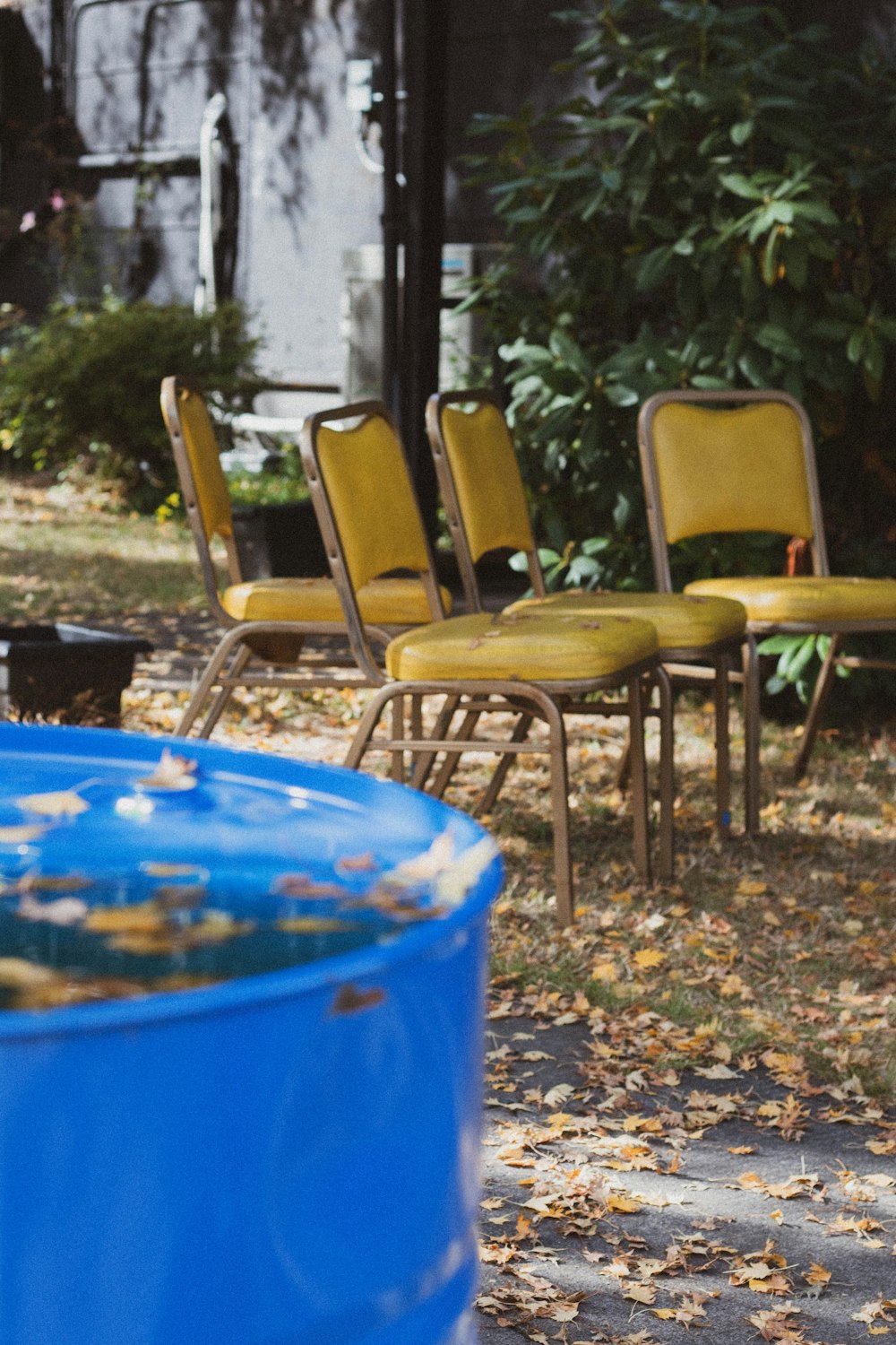 blue plastic container with brown wooden chair
