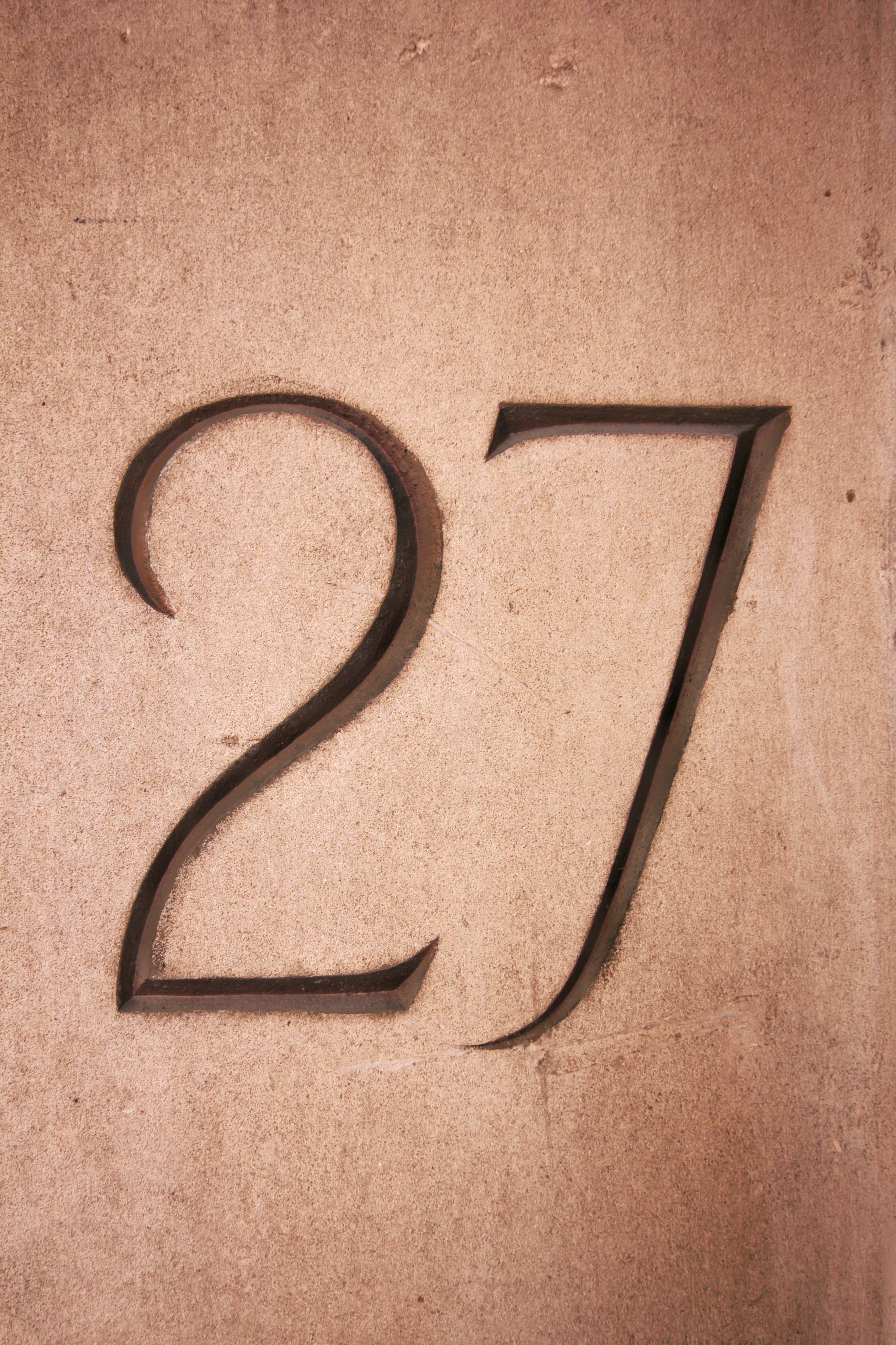 Street numbers engraved on stone.