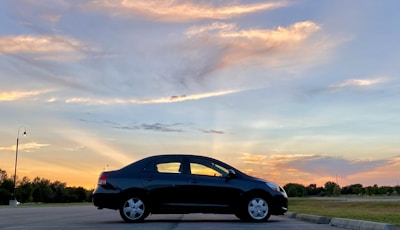A limousine with a beautiful sunset in the background.