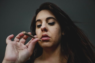 woman with red lipstick holding cigarette stick