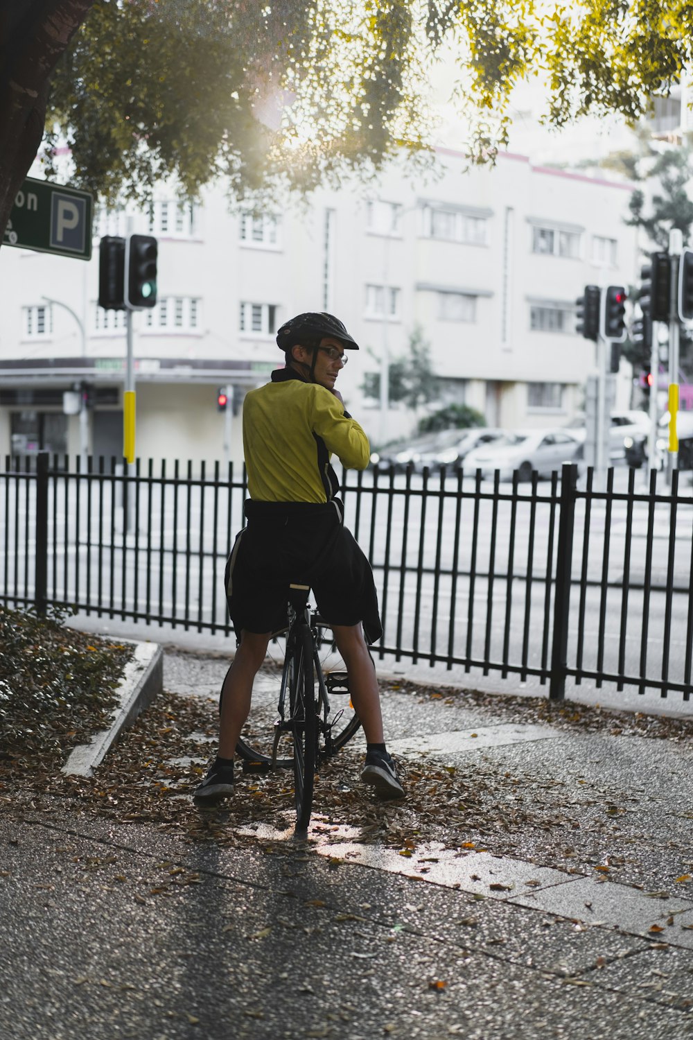 man in yellow shirt riding bicycle during daytime