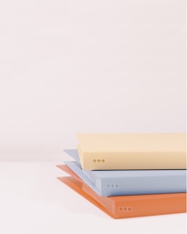 stack of books on white table