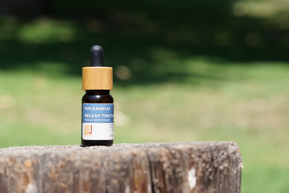 white and blue labeled bottle on brown wooden surface