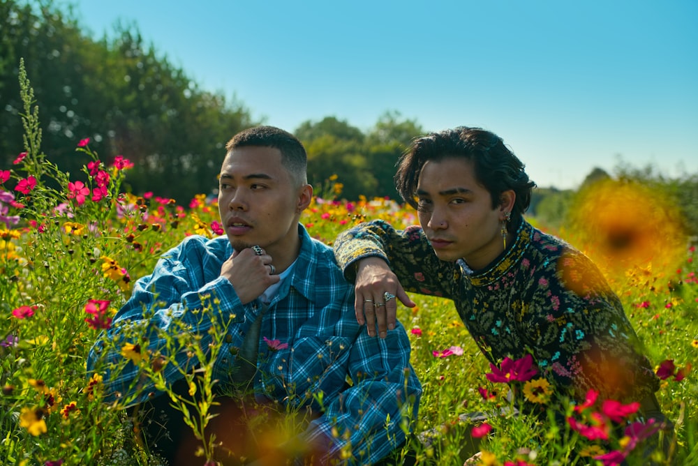 man and woman standing on flower field during daytime