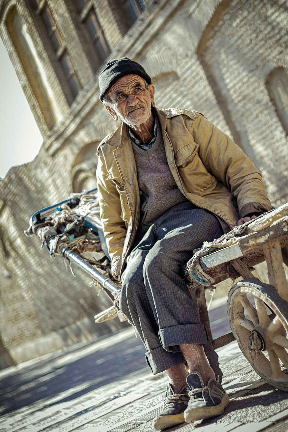 man in brown jacket sitting on bicycle during daytime
