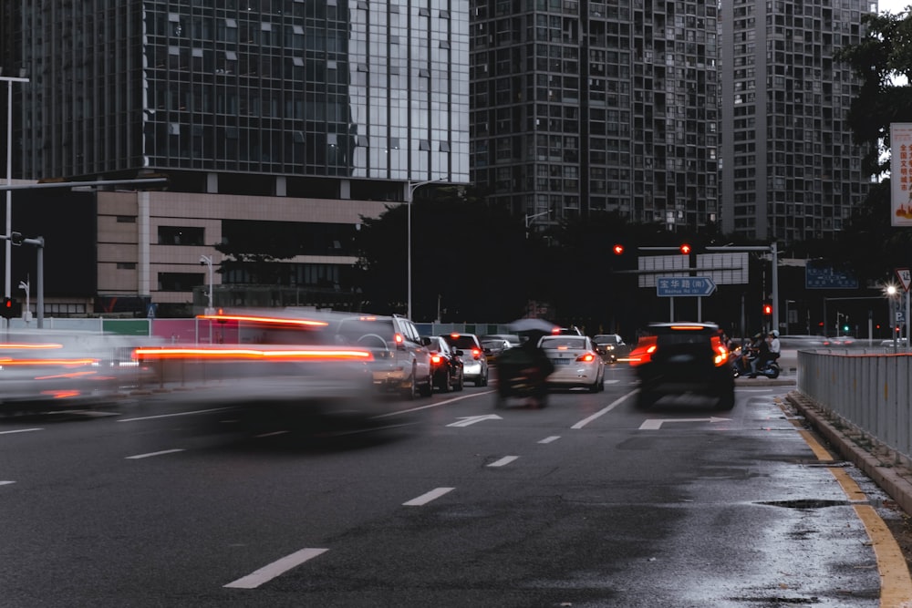 cars on road near high rise buildings during daytime