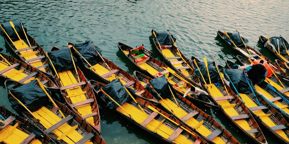 brown wooden boat on body of water during daytime