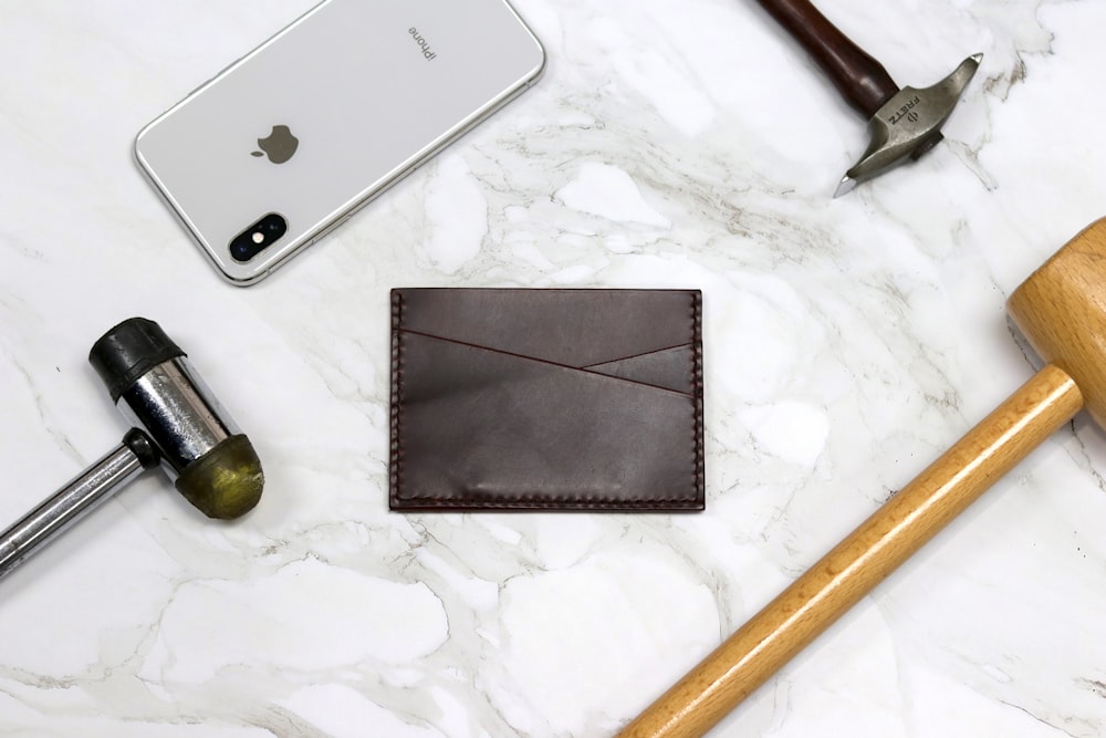 silver iphone 6 beside brown wooden handle knife