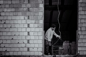 Craftsman installing electrical wiring in a renovated building