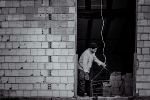 An electrician installing wiring in a newly constructed home.