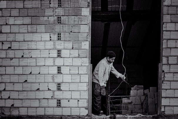 Technician installing electrical wiring inside a commercial warehouse