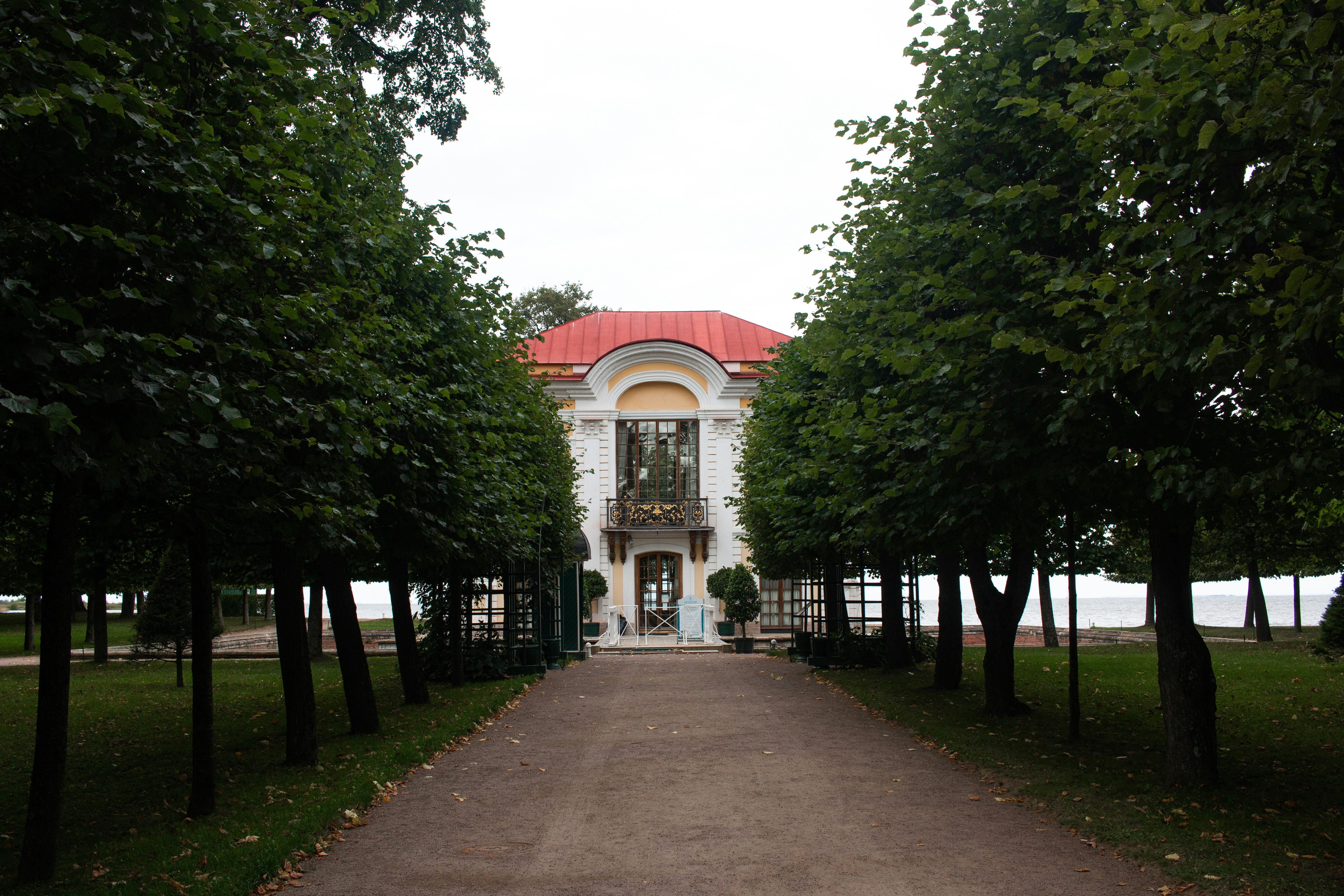 green trees near white and red building during daytime