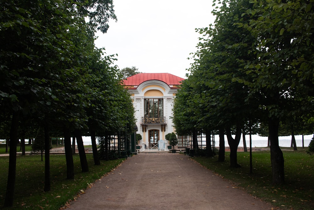 green trees near white and red building during daytime