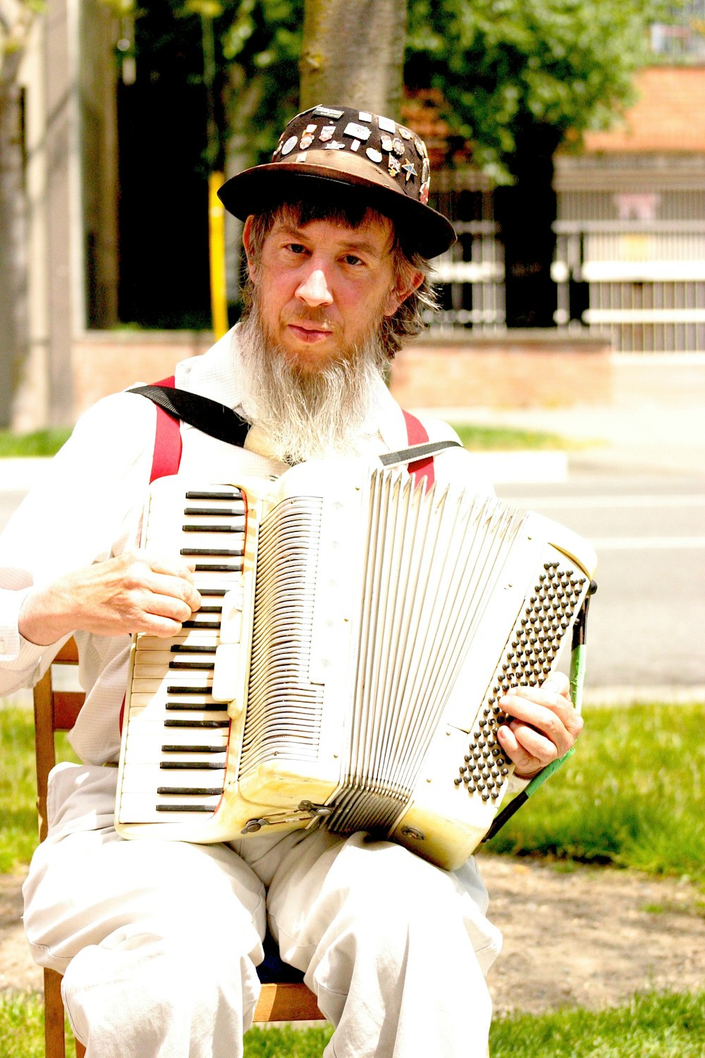 man in white and black striped long sleeve shirt playing white and black accordion