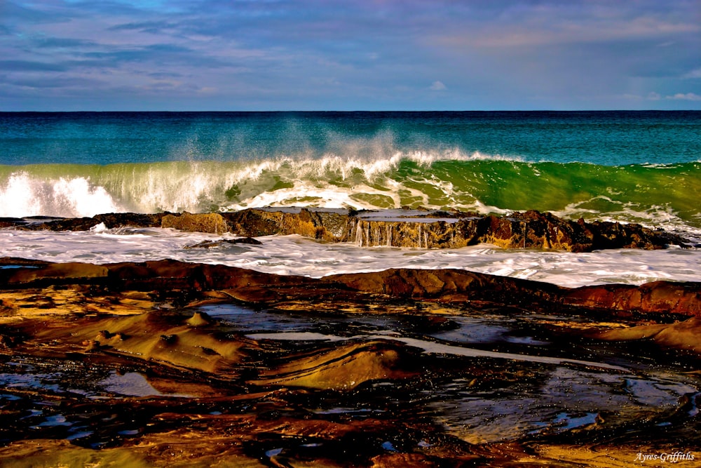 brown rock formation near sea during daytime