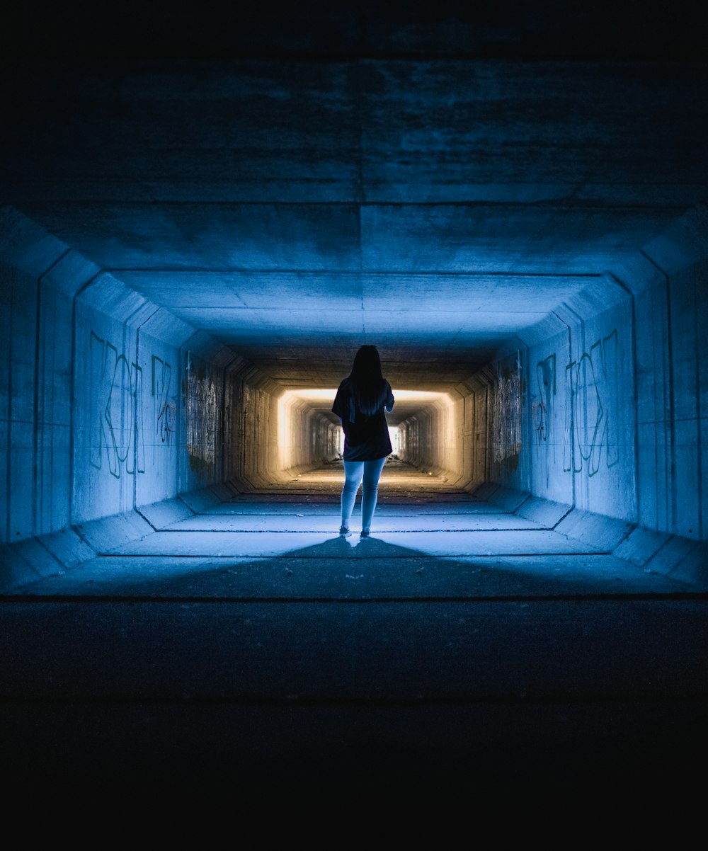 woman in black dress walking on hallway