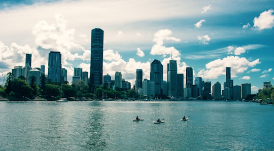 high rise buildings near body of water during daytime in Brisbane River Australia