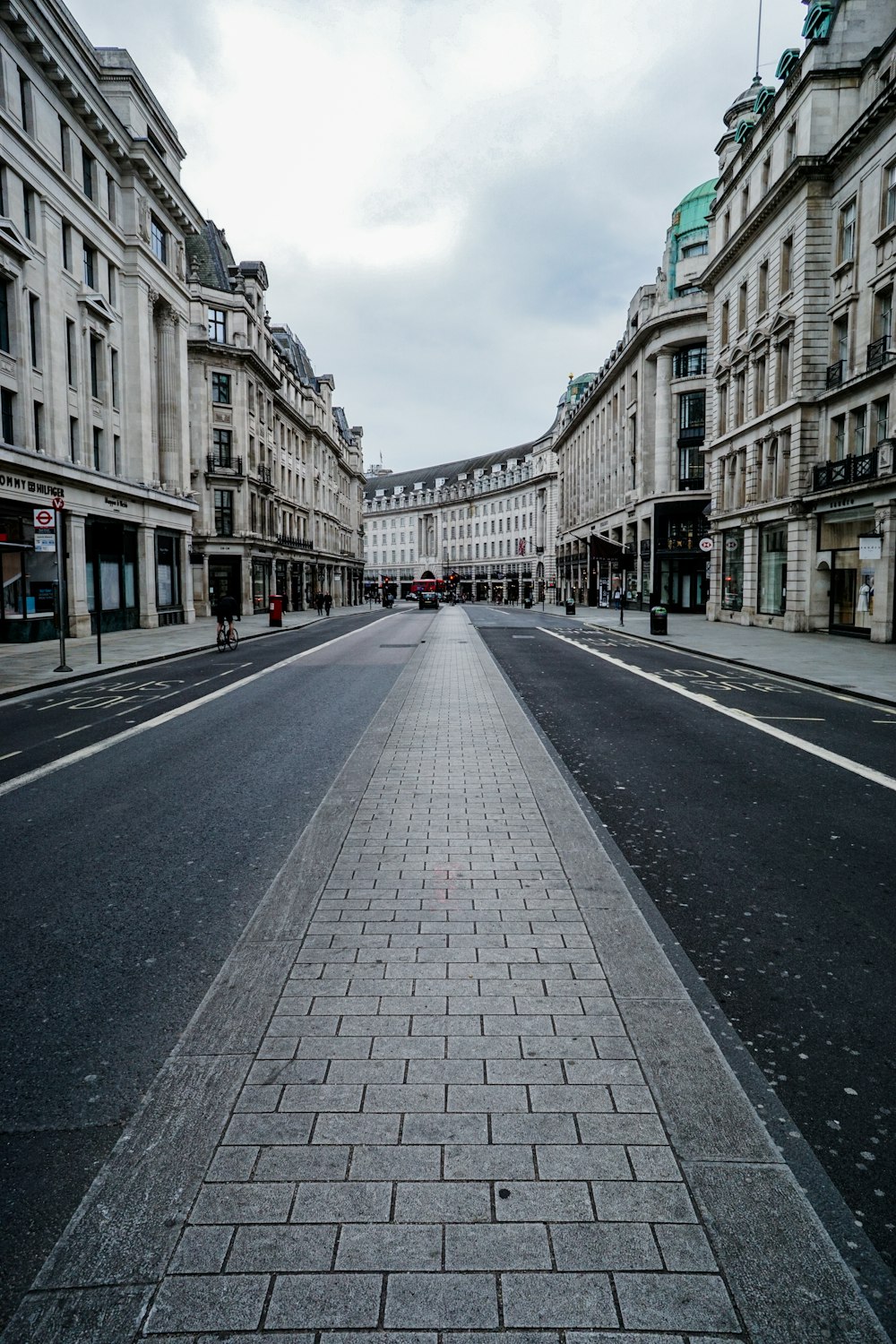 gray concrete road between buildings during daytime