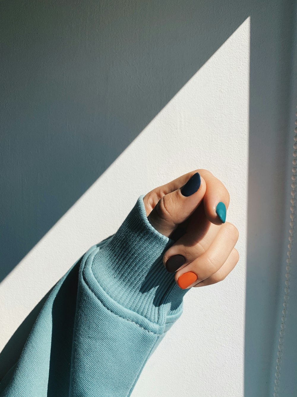 person in blue sweater holding blue textile