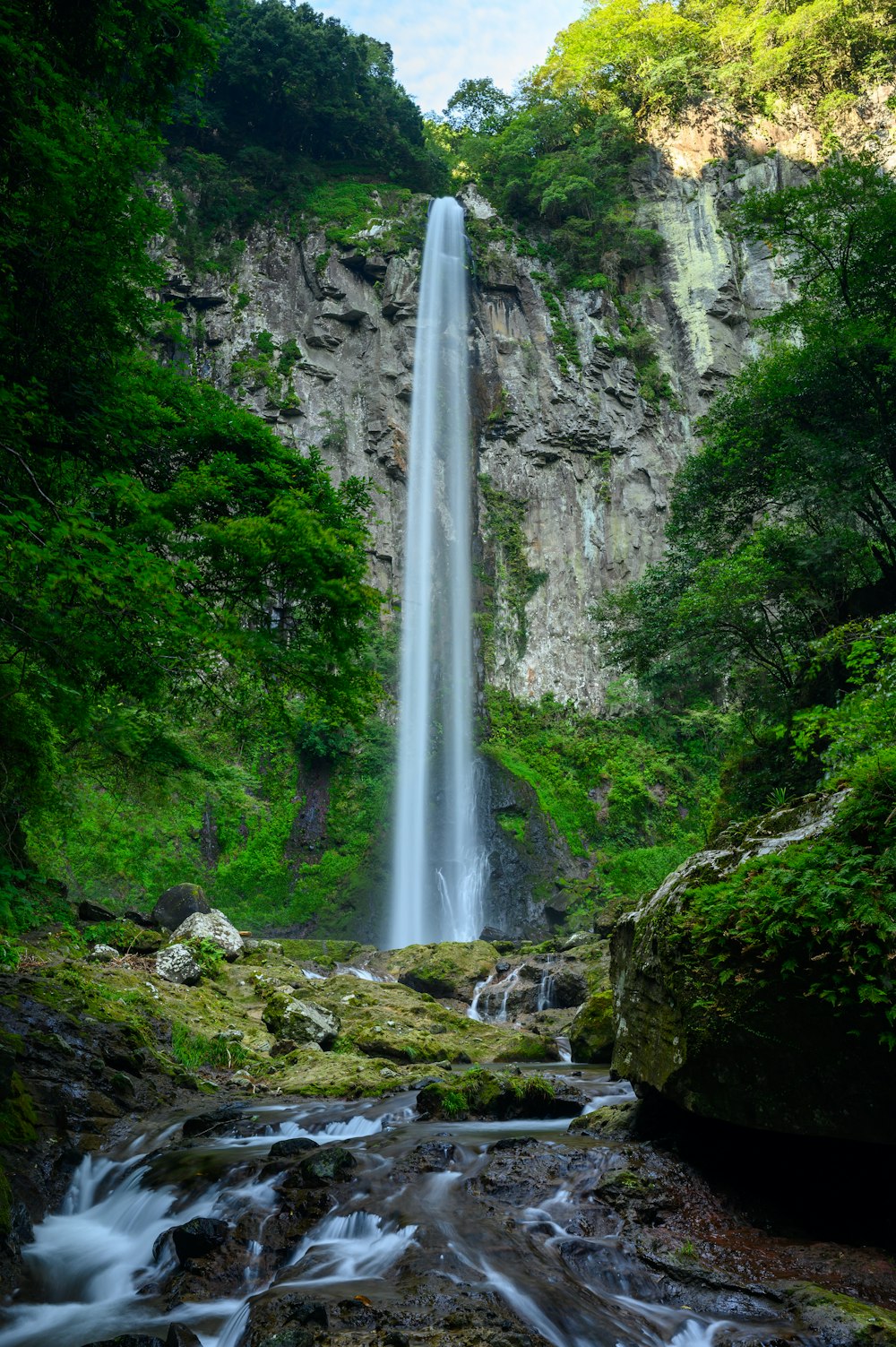 waterfalls on rocky mountain during daytime