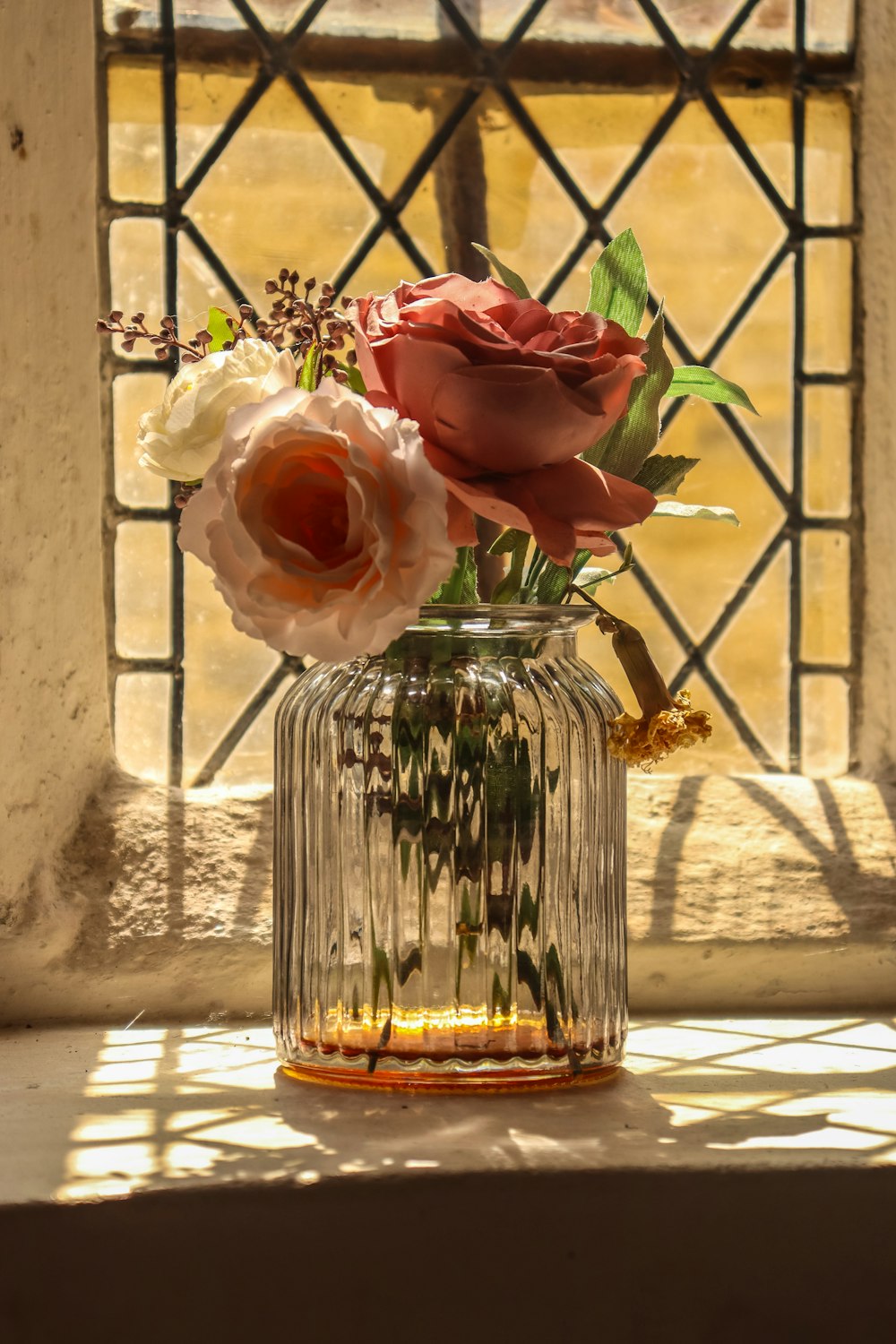 pink roses in clear glass vase