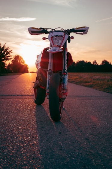 red motorcycle on road during daytime