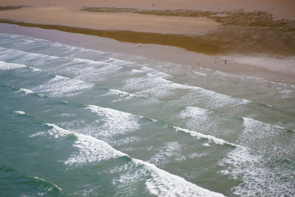 ocean waves crashing on shore during daytime