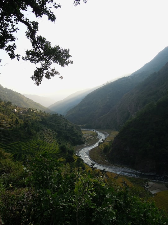 river between green mountains during daytime in Ramechhap Nepal