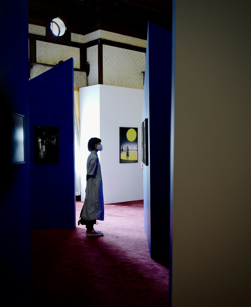 woman in white robe standing on hallway