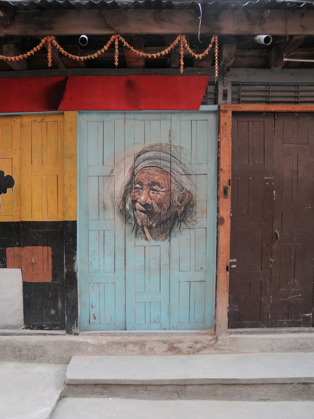 blue wooden door with womans face