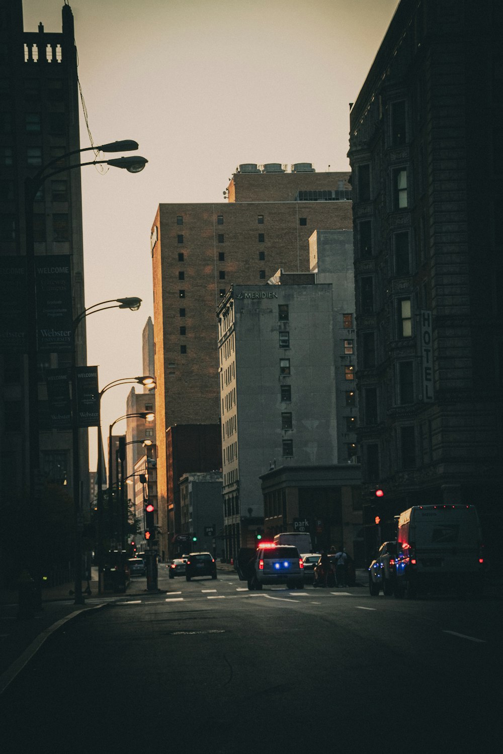 cars on road near high rise buildings during daytime