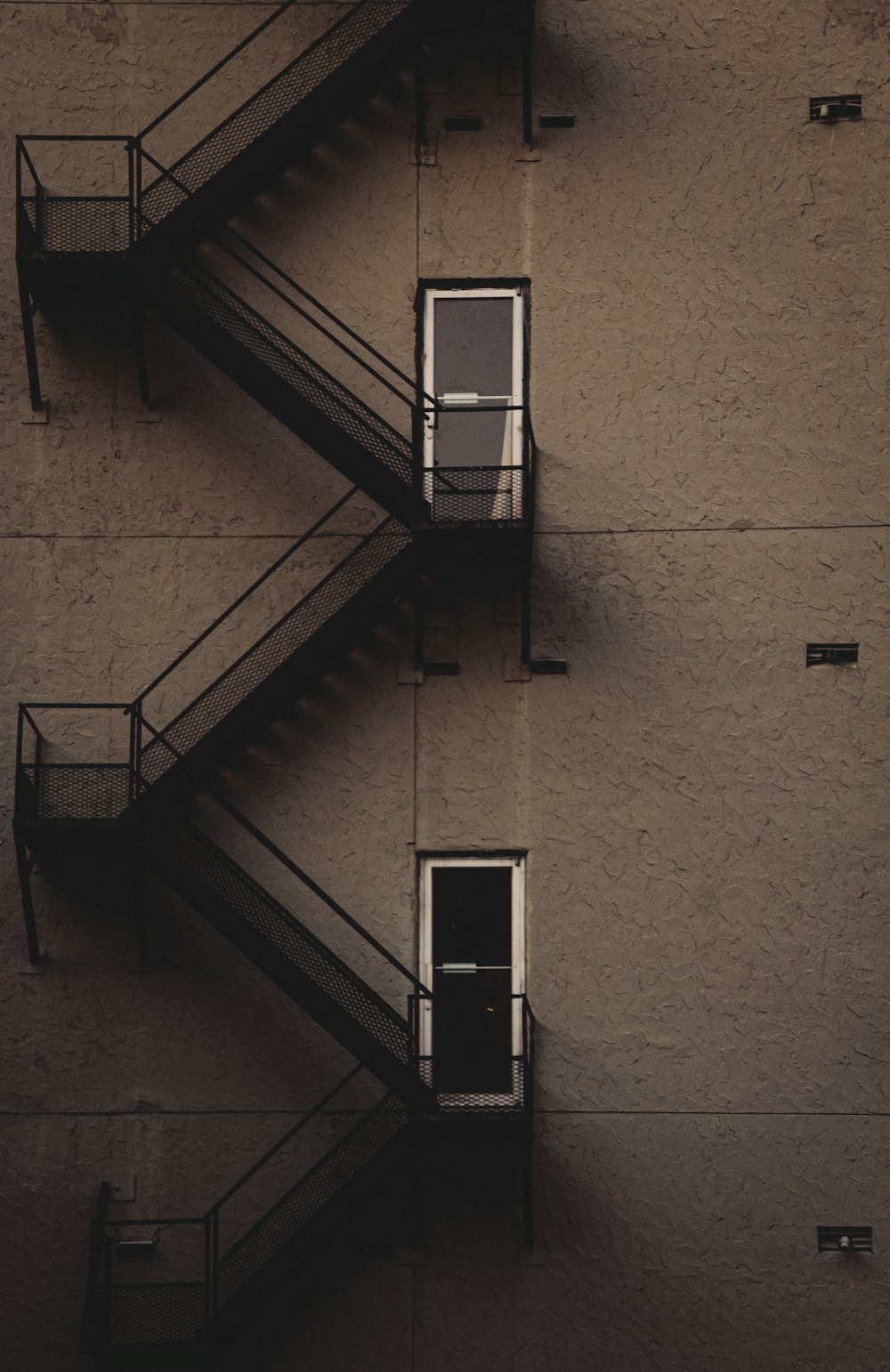 blue metal ladder on brown concrete wall