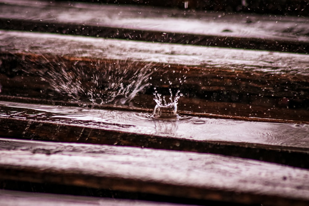 water splash on brown wooden surface